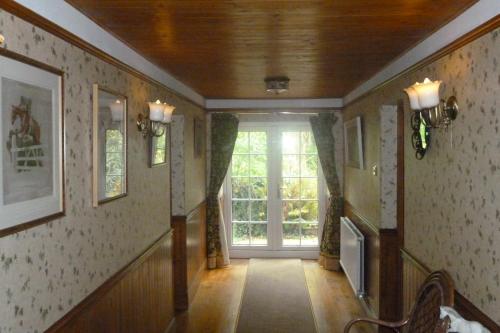 a hallway with a large window in a house at The Ramblers Retreat in Abergele