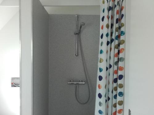 a shower in a bathroom with a shower curtain at Pension Stenvang in Onsbjerg