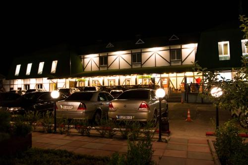 a parking lot in front of a building at night at Hotel Lubenska Sloboda in Vilʼshanka