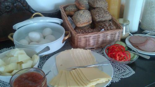 a table topped with cheese and bread and other foods at Pension Stenvang in Onsbjerg