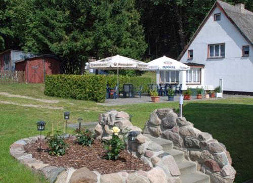 a garden with rocks and flowers in a yard at Selliner Pension am Waldrand in Ostseebad Sellin