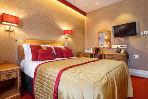 ロンドンにあるザ モンタナ ホテルのベッドとテレビが備わるホテルルームです。