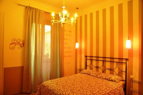 a bedroom with a bed and a chandelier at Il Moscondoro di MZ in Bologna