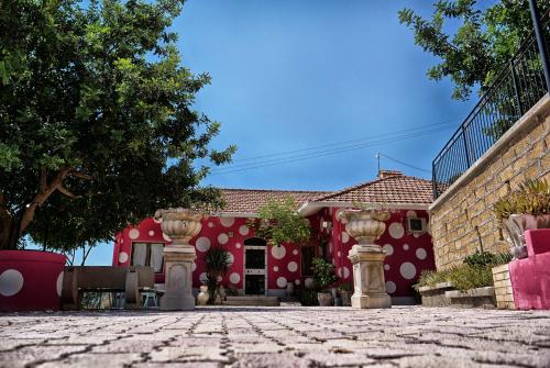 a red building with white polka dots on it at B&B Vento di Scirocco in Favara