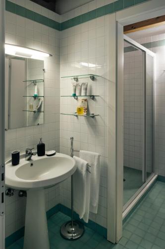 a white bathroom with a sink and a shower at Casa Lunia in Mestre