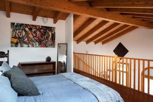 a bedroom with a bed and a painting on the wall at Casa Lunia in Mestre