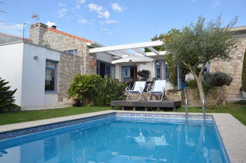 a swimming pool in the backyard of a house at HOMEinLAND of TERROSO - Privat Pool, Grill & Seaview in Póvoa de Varzim