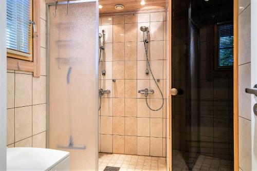 a bathroom with a shower with a glass door at Vuokatti Weekend Lux in Vuokatti