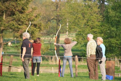 a group of people standing in a field with arrows at Ferienhof Radlandsichten in Malente