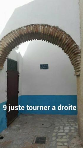 an arch in a building with the words justice volunteer a droid at Dar El Kasba Riad Guest House in Bizerte