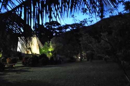 a view of a park with a building and trees at West Indies Cottage in Pointe-Noire