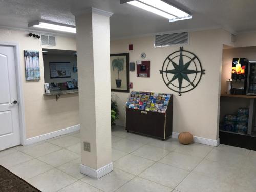a waiting room with a wheel on the wall at At Home Inn - Fort Pierce in Fort Pierce