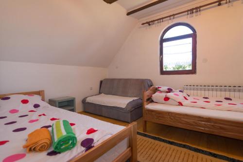 a small bedroom with two beds and a window at Vacation home Miki in Bajina Bašta