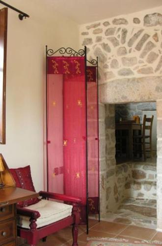 a room with a fireplace with a red door at Katafigi in Pirgos Dhirou