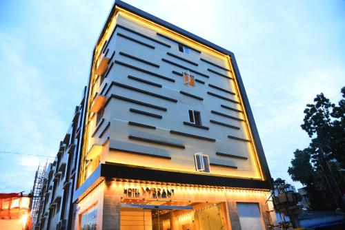 a building with a large clock on the side of it at Mango Hotels Vijayawada in Vijayawāda