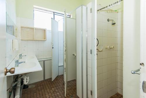 a bathroom with a sink and a shower at Victoria Park Lodge in Perth