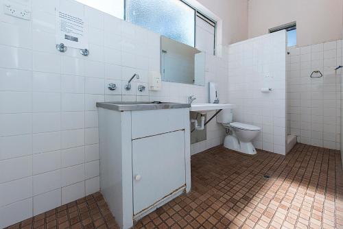 a bathroom with a sink and a toilet at Victoria Park Lodge in Perth