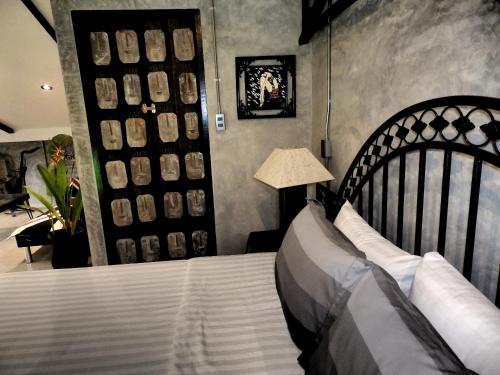 a bedroom with a large bed and a lamp at Rice Barn And Rooms in Hang Dong