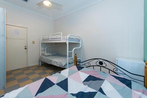 a bedroom with a bunk bed in a room at Victoria Park Lodge in Perth