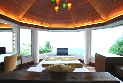 a bedroom with two beds and a wooden ceiling at Villa Ibarra in Tagaytay