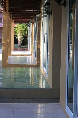 an empty hallway of a building with glass doors at Best House Resort in Ban Pak Ba Ra