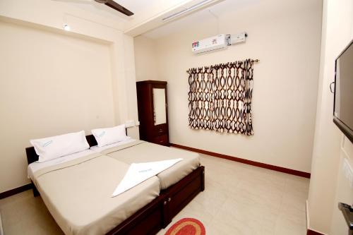Cama o camas de una habitación en Aditya Residency