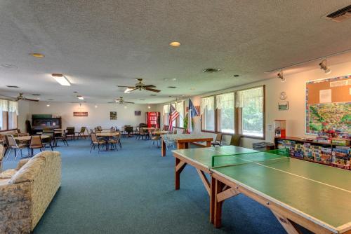 a room with a ping pong table and chairs at Colorado River Camping Resort Wheelchair Accessible Cabin 4 in Columbus