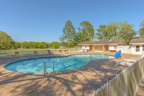 a swimming pool in a yard with a fence at Colorado River Camping Resort Wheelchair Accessible Cabin 4 in Columbus