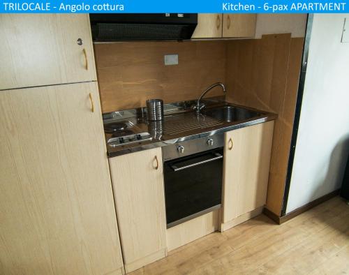 a small kitchen with a sink and a stove at Apartment Tonale in Passo del Tonale