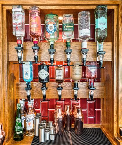 a bunch of bottles on a wall in a bar at Gwesty Gadlys Hotel in Cemaes Bay