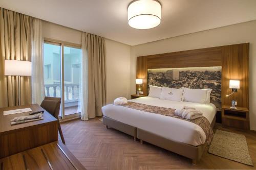 Tempat tidur dalam kamar di Melliber Appart Hotel
