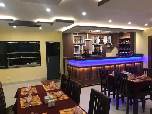 a restaurant with two tables and a bar at Kaveri Inn in Kathmandu