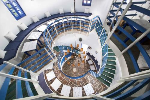 an overhead view of a spiral staircase with blue stairs at Kerame Studios & Apartments in Évdhilos