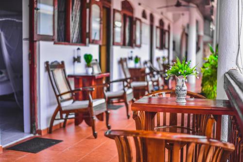 eine Reihe von Tischen und Stühlen in einem Restaurant in der Unterkunft Wijenayake's - Beach Haven Guest House - Galle Fort in Galle