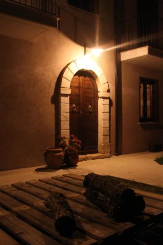 an entrance to a building with a wooden door at "il Casaletto" Agriturismo Moderno, Vista Panoramica e Cibo Spettacolare- Scurcola Marsicana in Scurcola Marsicana