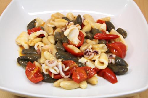 a white plate of pasta and vegetables on a table at "il Casaletto" Agriturismo Moderno, Vista Panoramica e Cibo Spettacolare- Scurcola Marsicana in Scurcola Marsicana