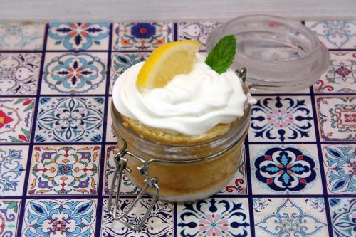 a dessert in a jar with a slice of lemon and whipped cream at "il Casaletto" Agriturismo Moderno, Vista Panoramica e Cibo Spettacolare- Scurcola Marsicana in Scurcola Marsicana
