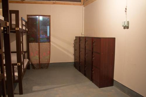 a room with a bunch of lockers and a door at Sook Jai Guest House in Chiang Rai