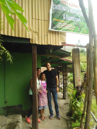a man and two children standing in front of a building at BATAD CRISTINA'S Main Village INN & Restaurant in Banaue