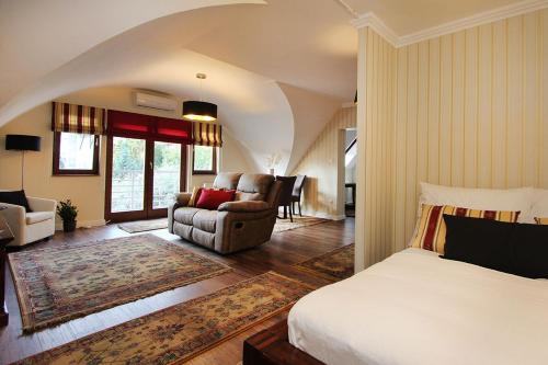 a bedroom with a bed and a living room at Good Luck Apartment in Hévíz