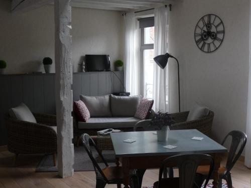 a living room with a couch and a table at Autrefois chez Lina in Dinant