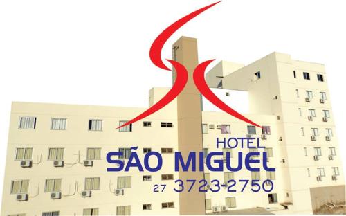 a sign for a hotel with a red ribbon at Hotel Sao Miguel in Collatina