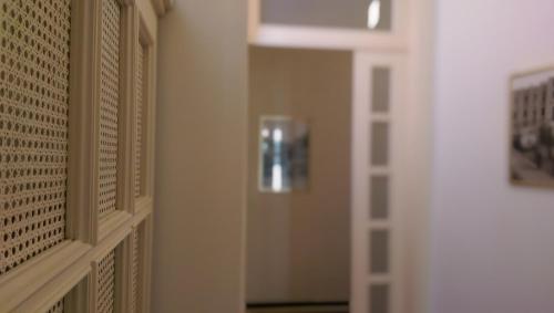 a hallway with a door with a fire extinguisher on the wall at B&B Porta di Mare in Catanzaro