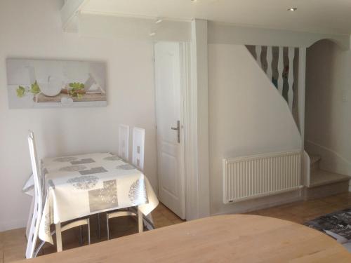 une salle à manger avec une table et un escalier dans l'établissement les gites du gr224, à Pont-Audemer