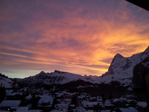 a sunset in the mountains with snow covered mountains at Chalet Schönbühl in Mürren