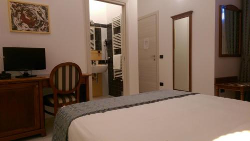 a bedroom with a bed and a desk and a television at B&B Porta di Mare in Catanzaro