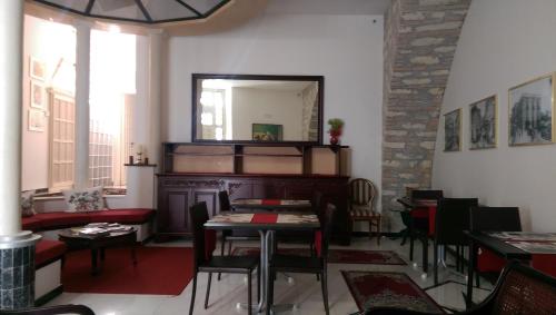 a dining room with a table and a mirror at B&B Porta di Mare in Catanzaro