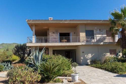 a house with a balcony with a dog on it at Sunset Beach House in Kato Alepochori