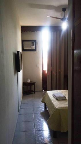 a bedroom with a bed and a television in a room at Coesa Hoteis in Casa Branca