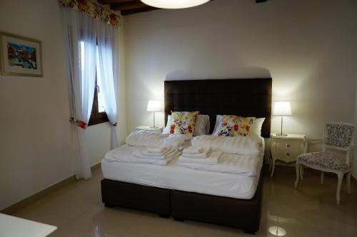 a bedroom with a large bed with white sheets and pillows at B&B HORTUS in Venice